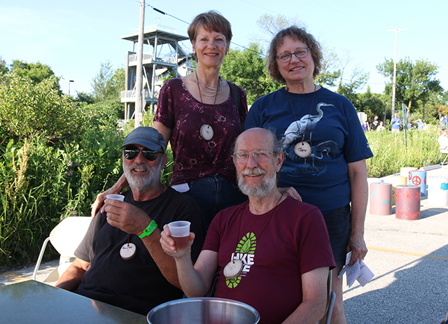 Dennis, his wife Jane, and friends sharing a beer at UEC's Grown Up Summer Camp