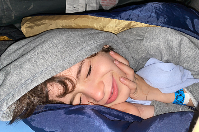 A child sleeping in a sleeping bag.