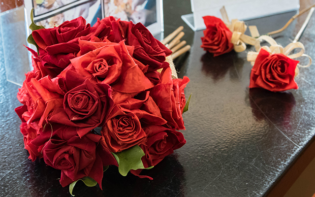 Paper roses in a bouquet and matching paper rose boutonnieres