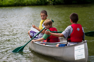 Boys take a canoe for a spin at a B'earthday Party
